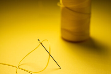 yellow thread in a needle