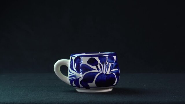 cup of talavera on elegant black background