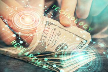 Double exposure of technology drawing hologram and us dollars bills and man hands. Data concept