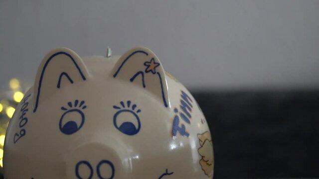 Geld in ein Sparschwein f&uuml;llen