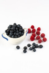 Raspberry and blue berry on white background in studio