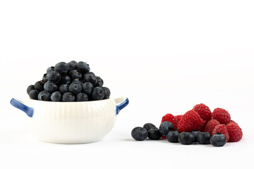 Raspberry and blue berry on white background in studio