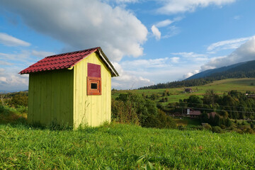Little green house in mountains