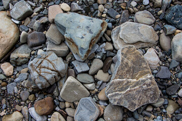 The surface of an old rock with cracks and moss. Old rock texture (wild background)
