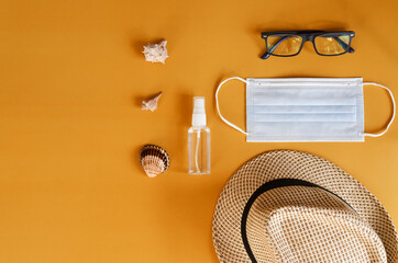 Travel under Covid-19 and new normal concepts. Top view of medical face mask, hand gel sanitizer,...