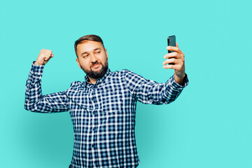 Portrait muscular unshaved man smiling and taking selfie photo isolated over color background 