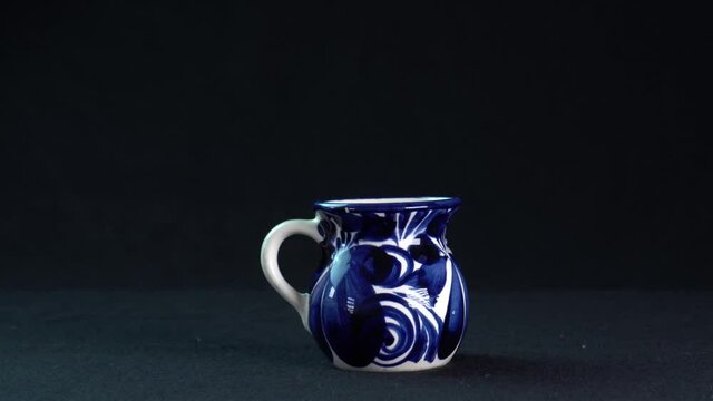 cup of talavera on elegant black background