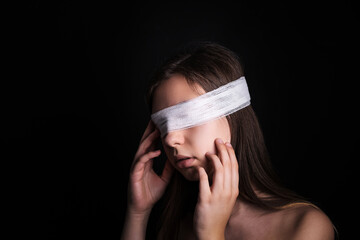 Blindfolded woman closeup. Concept of censorship, human rights, oppression or repression.