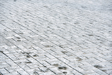 White salt stains on pedestrian paving slabs. Salty surface, salt on paving slabs outdoors. Rock...