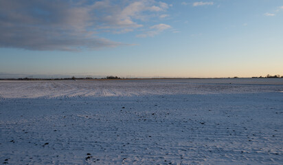 Panoramic view of snow covered frozen farm fields in Skåne Sweden during winter