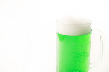 A pint of green beer for st patrick's day on a white background. Traditional Irish drink for a holiday