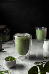 prepared matcha tea in a clear glass. a delicious drink made from Japanese green tea powder. vertical position