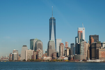panoramic views towards the tall glass skyscrapers in the financial district with the iconic Freedom tower in the center from Upper Bay Hudson River, New York City, New York, US
