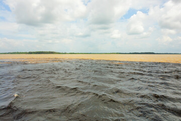  Meeting of the Waters of Rio Negro and the Amazon River or Rio Solimoes near Manaus, Amazonas, Brazil in South America.