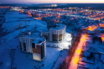 Construction of multi-storey buildings on the outskirts of the city, near the cottages.