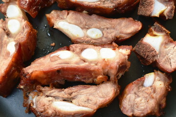 grilled pork bone slice dipping spicy chili sauce eat couple fresh cos lettuce vegetable on plate