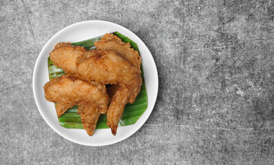 Close up Fried chicken wings on white dish.
