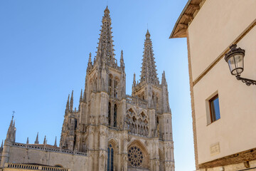 Fototapeta na wymiar Main facade of the Gothic Cathedral of Burgos on a sunny day. Burgos, Castilla y León, Spain
