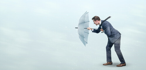 Businessman defying strong headwind