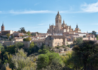 Fototapeta na wymiar Aerial view of the city of Segovia, its wall, the Cathedral of Our Lady of the Assumption, as well as the ancient medieval architecture, all of it a World Heritage Site by UNESCO