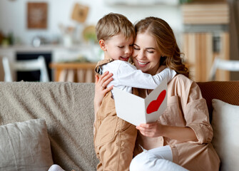 Mother and son reading greeting card