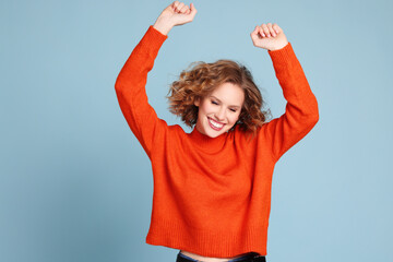 Delighted female dancing with closed eyes