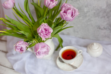 still life bouquet of tulips in a vase tea mug gift