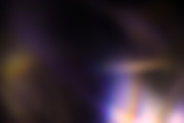 Blur colorful rainbow light leaks on black background. Defocused illuminated abstract retro film effect texture for using over photos as overlay or screen filter