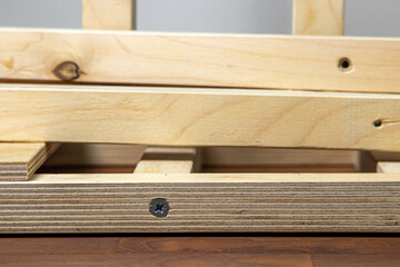 Wooden slats fastened to each other. Wood construction. Woodwork. Furniture assembly
