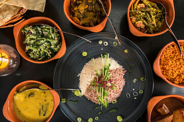An assotment of Sri Lankan dishes like red rice and different pickles.