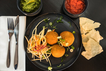 A Sri Lankan dish of fish cutlet balls and papadam bread.