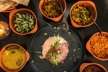 An assotment of Sri Lankan dishes like red rice and different pickles.