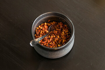 A bowl of chili flakes ata Sri Lankan restaurant.