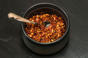 A bowl of chili flakes ata Sri Lankan restaurant.