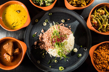 An assortment of Sri Lankan dishes and red rice.