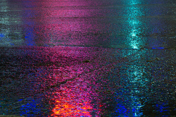 wet colored asphalt in the night city