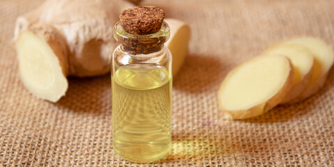 Ginger essential oil in a small bottle. Selective focus.