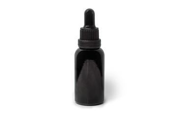 Black bottle of essential oil isolated on white background