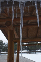Sharp and dangerous icicles hanging. Cold weather. Winter concept. Story background.