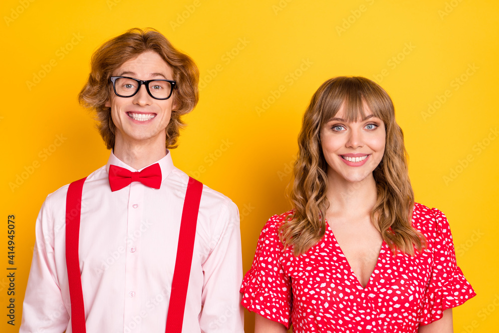 Sticker Photo of two satisfied young persons toothy smile look camera isolated on bright yellow color background