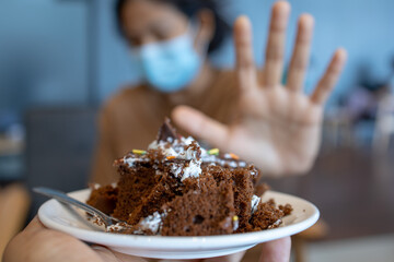 woman making sign of a cross rejects the cake