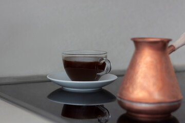 Fragrant black coffee is on the stove. Breakfast with coffee. Make coffee in a turk. Space for the text.