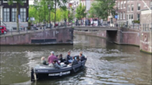 Tourism boat on urban canal river with passengers sailing