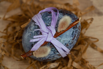 Beautiful Easter composition - colored eggs, similar to marble, ears of wheat, willow branches, traditionally, handmade