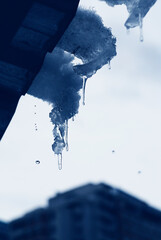 Melting icicle on the roof - view from the window. 