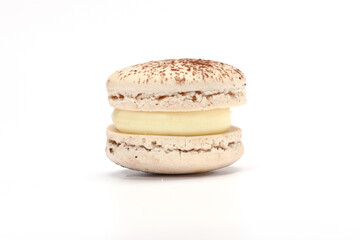 One cake of macaron or macaroon brown color. Delicious chocolate macaroon isolated on white background. French sweet cookie.