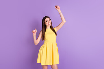 Portrait of attractive cheerful girl dancing having fun good mood isolated over violet purple pastel color background