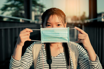 The new normal a girl wearing a mask during travel and public place. Covid-19 concept self-care.