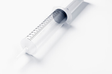 Large syringe on white background. Coronavirus vaccine and injections concept. Flu vaccination. Hospital syringe.