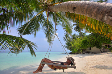 Girl relaxing on the hammock, Biyadhoo island, Maldives